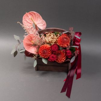 Composition in a wooden flowerpot with dahlias